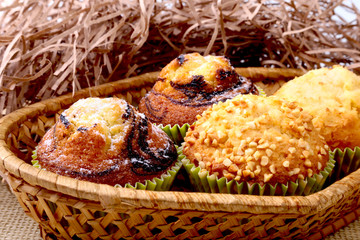 Wicker basket with assorted delicious homemade cupcakes with raisins and chocolate. Cupcakes. Top View. Copy space.