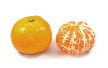 Peeled and whole tangerines close up on a white background