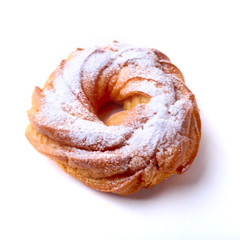 Chocolate and powdered sugar cream puff rings, choux pastry. Isolated on white background.