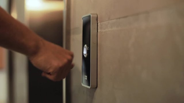 Close up hand young businessman presses a button of lift to go up by a finger elevator business technology lift push building interior down choice control office open door