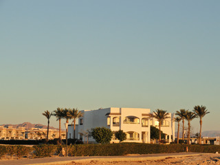 Egypt: Lonely standing building in the desert among the sands in the rays of the rising sun in the early morning.