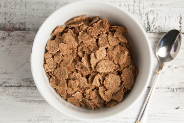 Cereal wheat flakes, spikes and rye grain on old rustic wooden table. Top view.