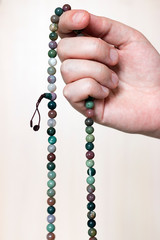 Hand with jasper rosary, beads meditation