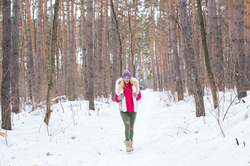 Fototapeta na wymiar Nature and people concept - Portrait of running young blond woman in the winter park