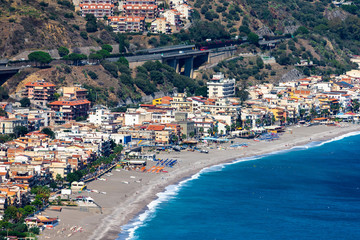 Beach view from Taormina.  Taormina has been main  tourist destination in Sicily since the 19th century. Taormina, Sicily, Italy. - obrazy, fototapety, plakaty