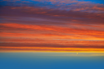 Naklejka na ściany i meble Sunset clouds sky in orange and blue