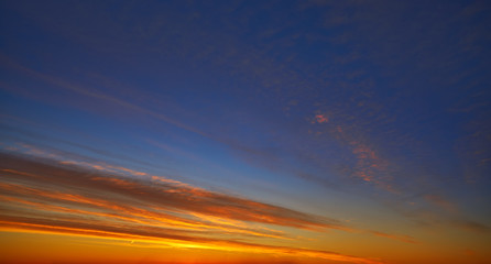 Fototapeta na wymiar Sunset clouds sky in orange and blue