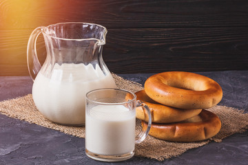 Bagels with milk in a jug on the table still life