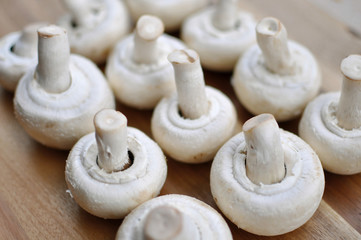 Champignons mushrooms on a wooden background, close-up