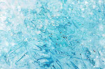 Marbled turquoise, blue and white abstract background with golden sequins. Liquid marble ink pattern. Modern artwork. Unique texture.