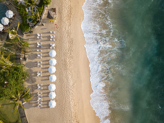 Overhead view of beach umbrellas and sun loungers on beach
