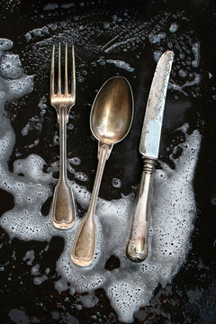 Silver cutlery getting cleaned