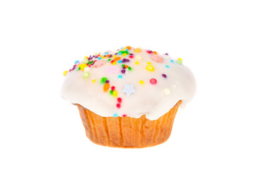 Delicious homemade muffin with white fondant and colorful sugar sprinkles icing isolated on white background.