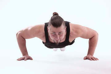 Fototapeta na wymiar athletic man performs push-up from the floor.isolated on white background