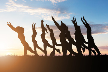 Class doing aerobics balancing on boards