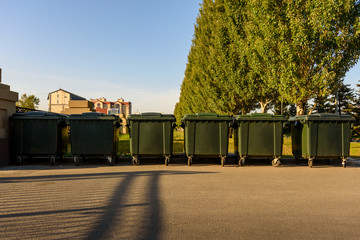 several plastic green garbage containers in the city Park, separate waste collection, recycling, ecology