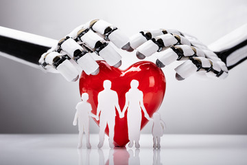 Robot Protecting Family Figures With Red Heart