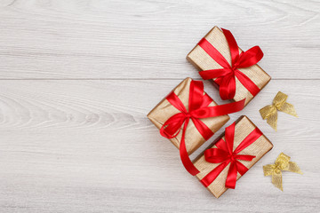 Three gift boxes on gray wooden background