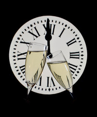 CELEBRATION OF THE NEW YEAR, glasses raising with champagne with the clock unfocussed