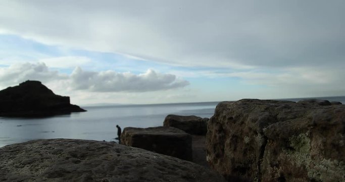 A Man Walking In Giant's Causeway Northern Ireland