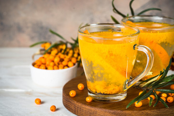 Sea buckthorn tea with orange in a glass cups.