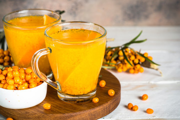 Sea buckthorn tea with orange in a glass cups.