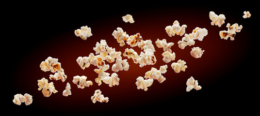 Popcorn isolated on black background. Falling or flying popcorn. Close-up