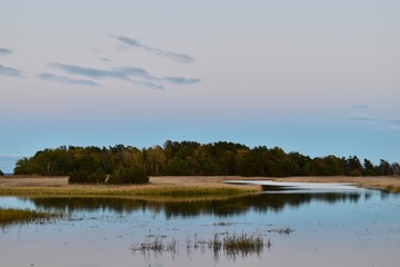 Obraz na płótnie Canvas view on little island in evening ligth, baltic sea coast, Klamar, Sweden