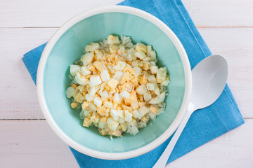 Step by Step Cooking Salad with Crab Stick, Corn and Rice - Step - 1 Adding Eggs, top view