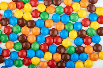 Obraz premium Abstract pattern with round color candy on background. Colorful sweets top view. Flat lay image