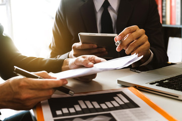 Business and human resources concept. Examiner reading a resume during job interview at office with smart phone and calculator digital tablet and graph 