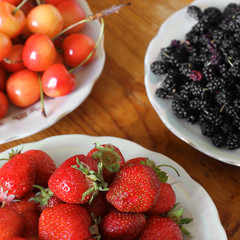 Strawberries, cherries and mulberries on the table