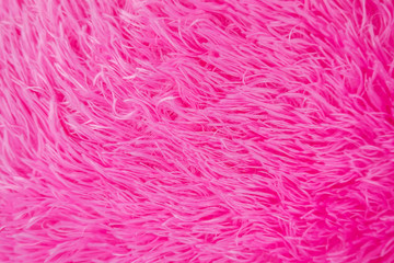 Close up pink shaggy artificial fur texture or carpet for background.