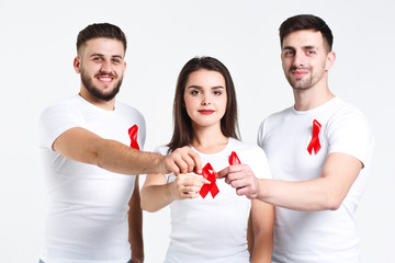 Group of friends  with watercolor of red ribbon .world AIDS day concept. On the white background