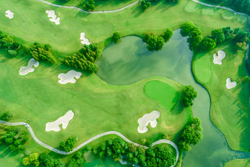 Aerial photograph of forest and golf course with lake