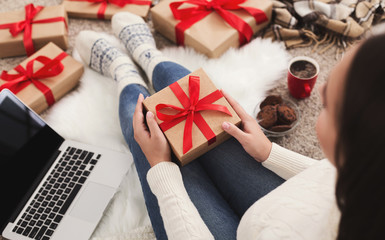 Ordering presents. Woman holding a Christmas gift