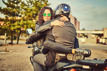 Young woman resting sitting on a motorcycle . Travel and tourism concept