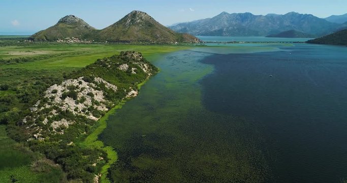 Aerial view of the beautiful landscape of Lake Skadar in the mountain on a sunny day. Montenegro. The territory of Lake Skadar overgrown with plants.