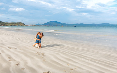 mother and daughter hugging on the beach