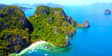 Exotic Beach Cove With Catamaran Style Boats On Rocky Tropical Island - El Nido, Palawan, Philippines - Aerial View - obrazy, fototapety, plakaty