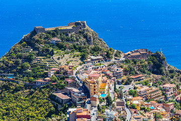 Naklejka premium The view from the small village Castelmola at mountain top above Taormina, with the view of Mediterranean Sea and the skyline of Taormina.