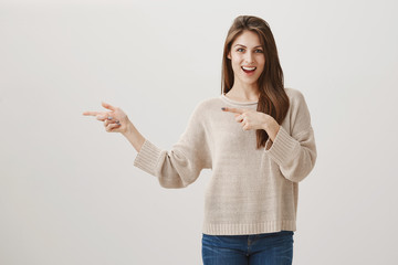 Let us hit that bar and shake up night. Portrait of happy excited european brunette pointing left...