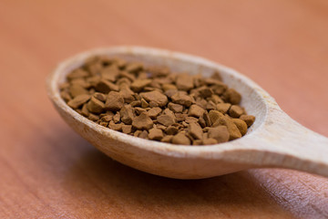 Wooden spoon of coffee close up