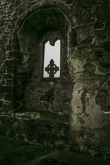 Fototapeta na wymiar Stone cross though Window