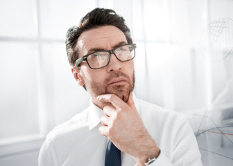 pensive businessman standing near a transparent Board