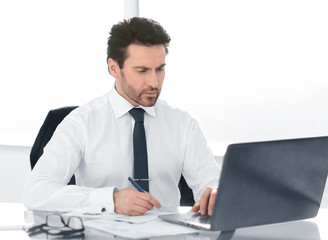 close up. serious businessman checking financial report