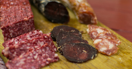 Smoked sausages are cut on a cutting board.