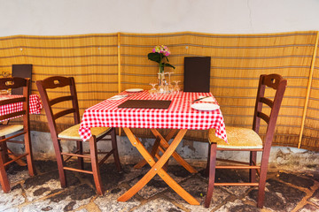 Picturesque tables and chairs in a narrow alley in old town Sorrento