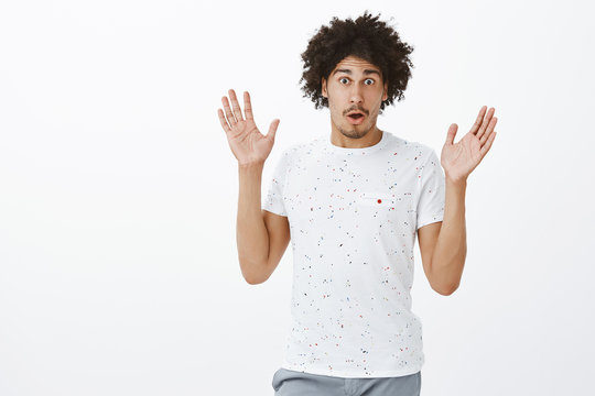 Excited And Emotive Handsome Male Describing Huge Boom Happened On Street. Portrait Of Good-looking Surprised And Shook Hispanic Man With Moustache Gesturing With Raised Palms While Talking