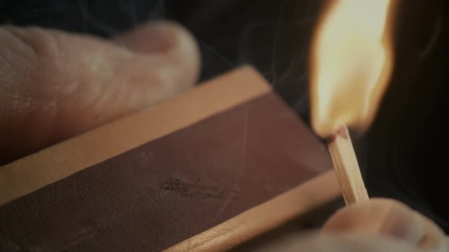 Ignition of match with smoke, isolated on black background.